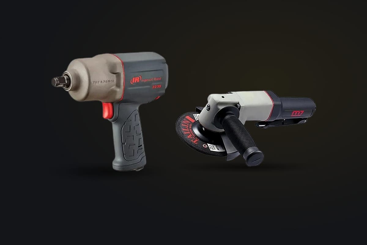 Llave de impacto y pulidora neumáticas sobre fondo grafito